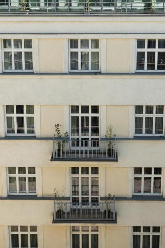 a building with windows and balconies with plants on them at K+K Hotel Fenix in Prague