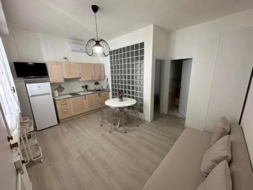 a kitchen with a table and a kitchen with a sink at Monolocale Portoverde Beach in Misano Adriatico