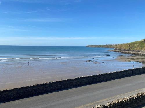 a road next to a beach with the ocean at Holiday Apartment Iris in Waterford