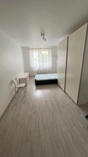 a bedroom with a bed and a desk and a chair at flat 6A in Gorzów Wielkopolski