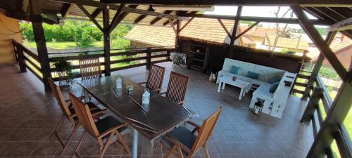 a patio with a table and chairs and a couch at Pri Fiškušu in Duga Resa