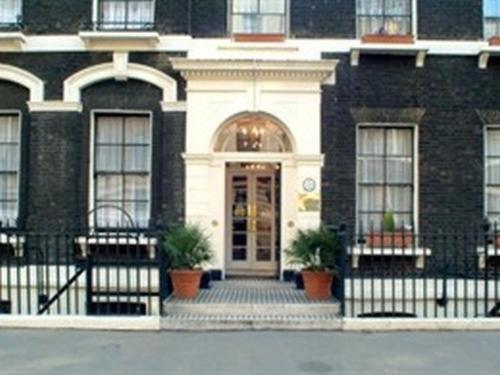 a black and white building with a door at Garth Hotel in London