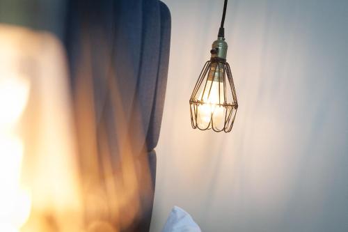 a light fixture hanging from a wall next to a curtain at 5 Star - The Ulsterville Residences - Free On-site Parking in Belfast
