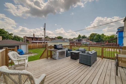 a wooden deck with a grill and chairs on it at Spacious Chicago Condo with Deck Less Than 9 Mi to Downtown! in Oak Park