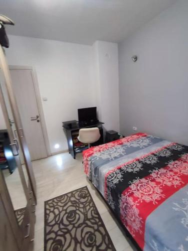 1 dormitorio con 1 cama y escritorio con ordenador portátil en Nikolaj en Podgorica