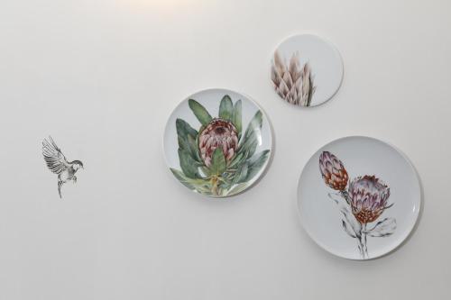 a group of plates with flowers on them at Montebelo Vista Alegre Lisboa Chiado Hotel in Lisbon