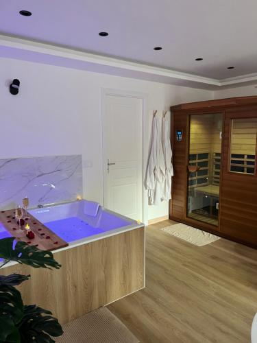 a jacuzzi tub in the middle of a room at L’Eden d’Opale in Coquelles