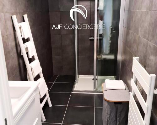 a shower with a glass door in a bathroom at Appart'hotel grande terrasse vue mer in Ajaccio