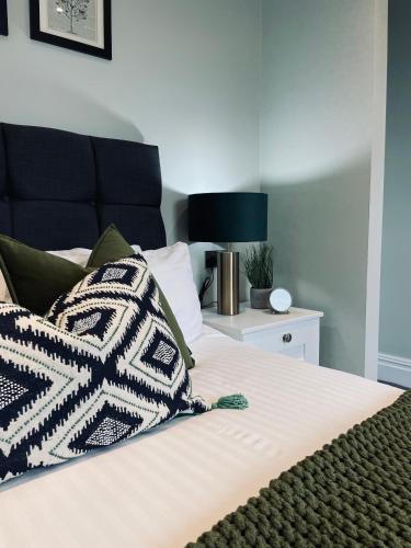 a bed with two pillows on top of it at 5 Star - The Ulsterville Residences - Free On-site Parking in Belfast