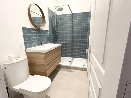 a bathroom with a toilet and a sink and a mirror at Pleasant 3-bedroom flat in the center of Marseille in Marseille