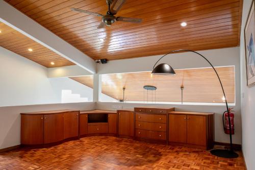 a room with wooden ceilings and a ceiling fan at Kontor Mansion - 3 mins to Teluk Chempedak Beach & Private Pool in Kuantan
