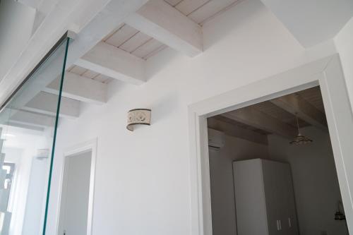 a white room with a mirror and a window at Casa Lussu in Lipari