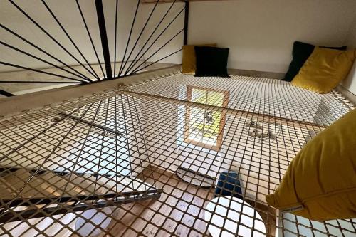 a cage in a room with a window at Les gîtes du Canal du midi - Gîte Loft'Oten in Avignonet-de-Lauragais
