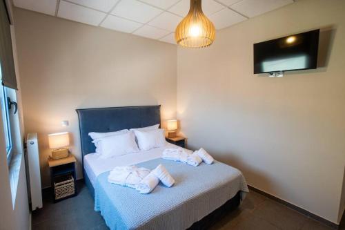 a bedroom with a bed with towels on it at Luxury Apartment in Chalkida #2 in Chalkida