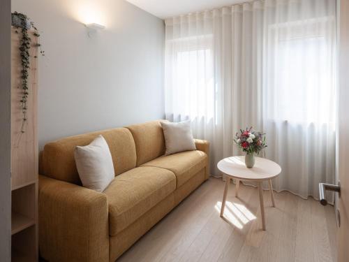 a living room with a couch and a table at Dianthus Apartment in Lana