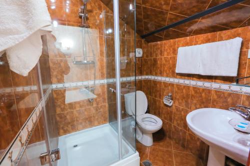 a bathroom with a shower and a toilet and a sink at Tbilisi My House in Tbilisi City