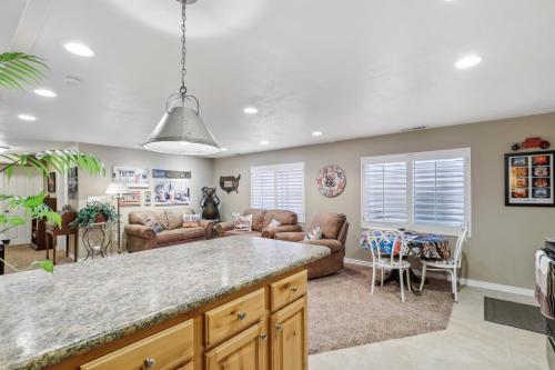 a kitchen and living room with a large island at Cozy American Fork Retreat with Electric Fireplace in American Fork