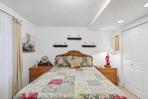 a bedroom with a bed with a quilt on it at Cozy American Fork Retreat with Electric Fireplace in American Fork
