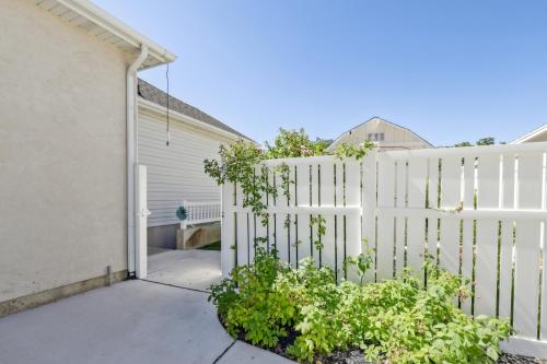 a white fence in front of a house at Cozy American Fork Retreat with Electric Fireplace in American Fork