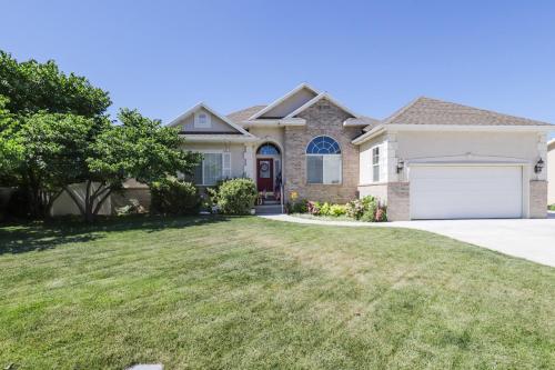a house with a driveway and grass at Cozy American Fork Retreat with Electric Fireplace in American Fork