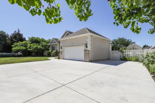 a large driveway with a garage in front of a house at Cozy American Fork Retreat with Electric Fireplace in American Fork