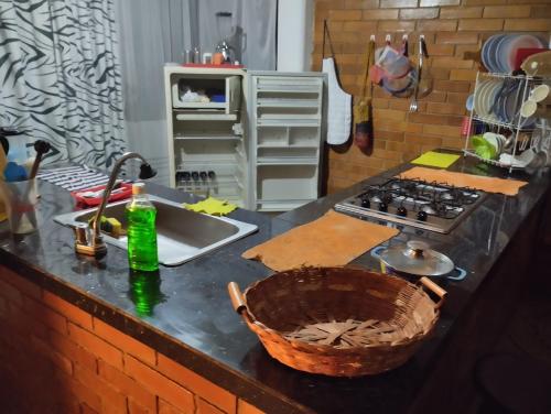 a kitchen counter top with a sink and a stove at CABAÑA 5-1 CONDOMINIO LOS SAUCES MONIQUIRA in Moniquirá