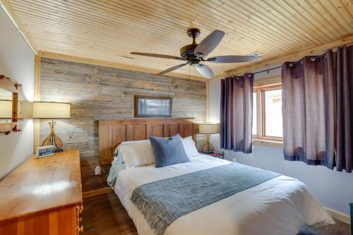 a bedroom with a bed and a ceiling fan at Lakefront Cottage with Deck Near Indiana Beach! in Monticello