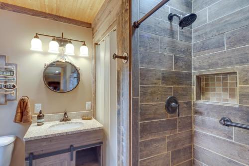 a bathroom with a shower and a sink at Lakefront Cottage with Deck Near Indiana Beach! in Monticello
