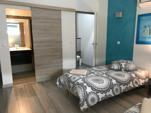 a bedroom with a large bed and a bathroom at AU POINT DE VUE DE LA ROCHE in Morey