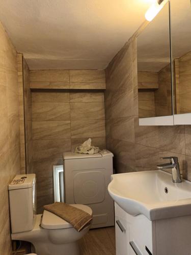 a bathroom with a toilet and a sink at Tenok Boutique Home in Tinos