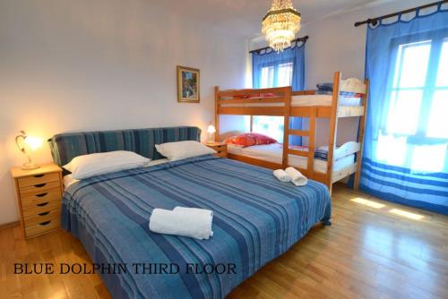 a bedroom with a blue bed and a bunk bed at Vila Nada Piran in Piran