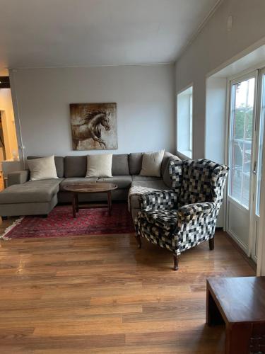 a living room with a couch and a chair at Lindelunda in Åhus