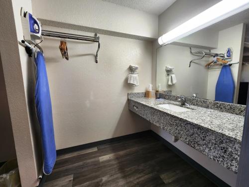 a bathroom with a sink and a mirror at Highland Inn in Arlington