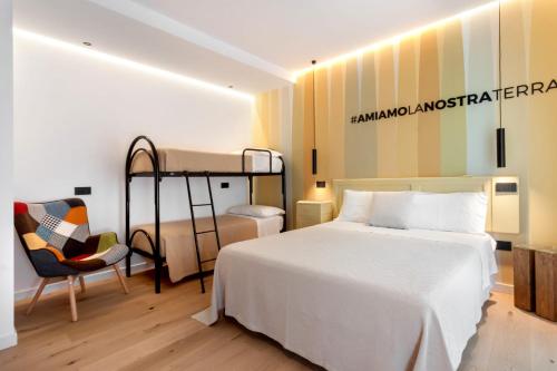 a bedroom with a bunk bed and a chair at La Sentina Experience in San Benedetto del Tronto