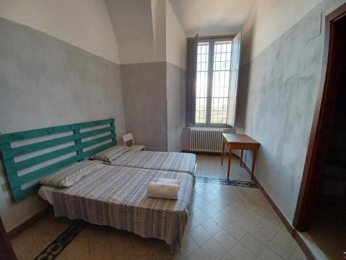 a bedroom with a large bed and a window at Domus Narnia in Narni