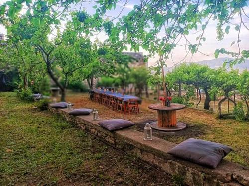 a row of tables with pillows in a park at Domus Narnia in Narni