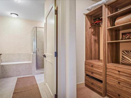 a bathroom with a shower and a walk in closet at Halii Kai 20D in Waikoloa