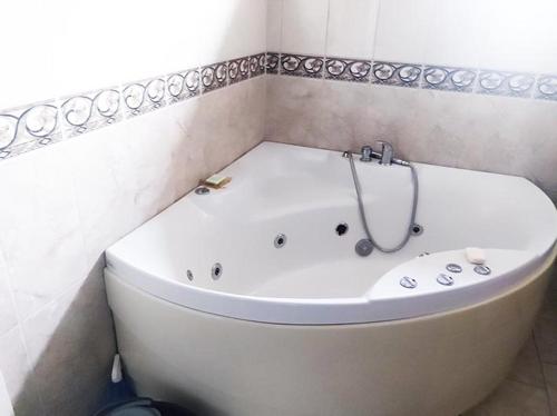 a white bath tub in a bathroom with at Hus Solgläntan in Ruda