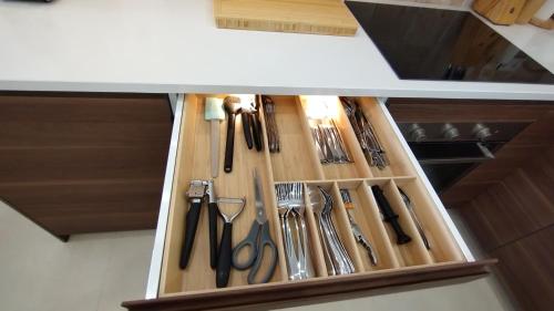 a drawer filled with lots of utensils at Casa da Torre - A Gema Escondida de Tavira in Tavira