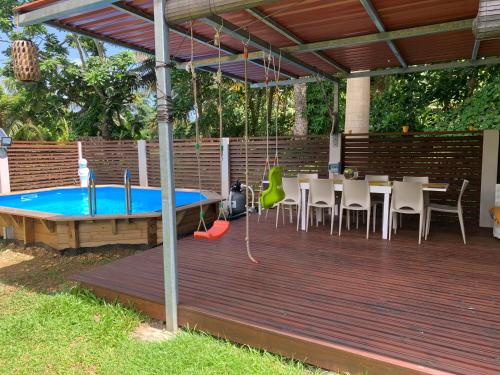 a wooden deck with a ping pong table and a ping pong table at Villa CIDEHO in Lamentin