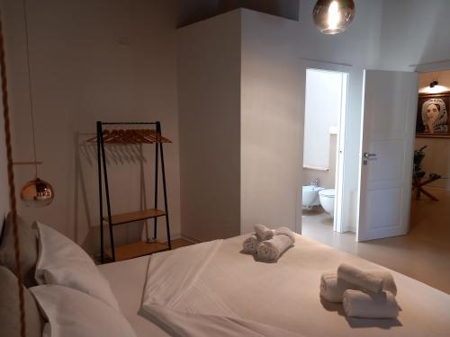 a bedroom with a bed with towels on it at La casetta Guest House Oristano in Oristano