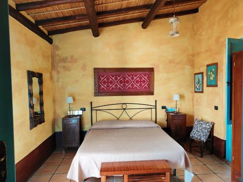 a bedroom with a large bed in a room at Sa Corti De Sa Perda Piscinas in Piscinas