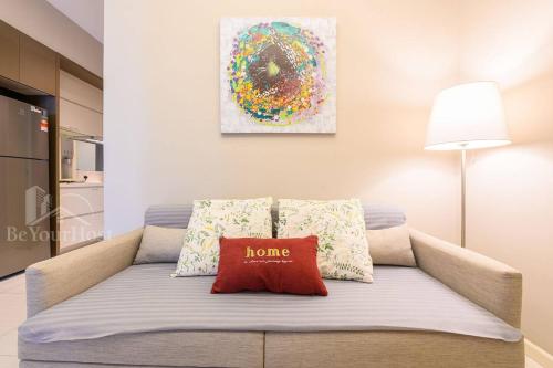 a couch with a red pillow on it in a living room at Dorsett Residences Sri Hartamas (Kuala Lumpur) in Kuala Lumpur