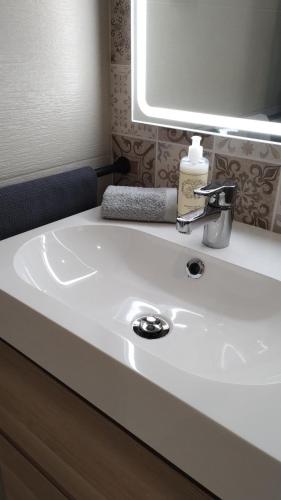 a white sink in a bathroom with a mirror at Casa da Torre - A Gema Escondida da Tavira in Tavira