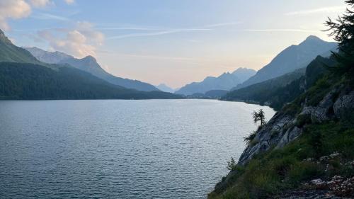 a view of a lake with mountains in the background at Chesa Munteratsch 1 1 2-Zimmerwohnung 209 Typ D in Silvaplana