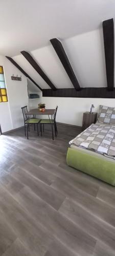 a bedroom with a bed and a table in a room at Ubytování Jevišovka - Vinný sklípek in Jevišovka