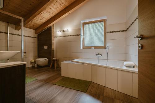 a bathroom with a tub and a sink and a toilet at Ferien und Familienhaus Robert Haider in Innervillgraten