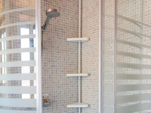 a bathroom with a shower with a wall at Casa rural fuente de la mora in Uña