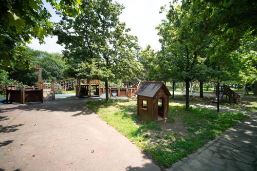 a park with a dog house and a playground at Oasis Luxury - A.C/Terrace/2Bedrooms in Bergamo