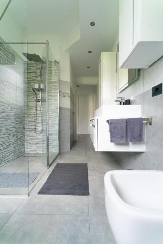 a bathroom with a tub and a sink and a shower at Oasis Luxury - A.C/Terrace/2Bedrooms in Bergamo